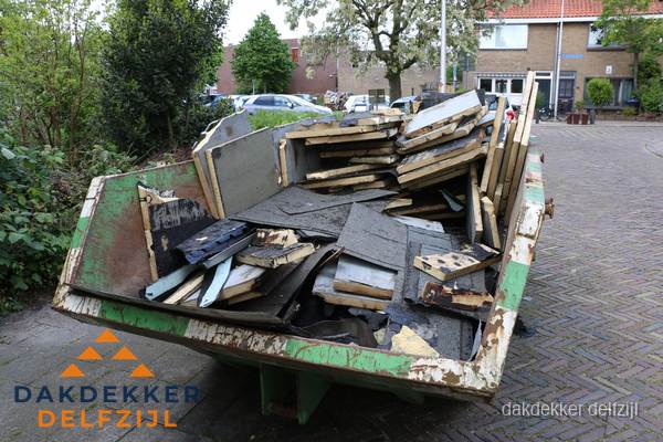 Puincontainer met oud dakmateriaal na dakrenovatie in Delfzijl