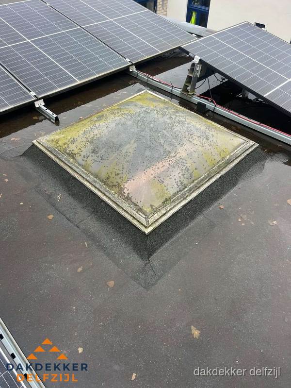 Vervuilde lichtkoepel op plat dak met zonnepanelen in Delfzijl Vervuilde lichtkoepel op plat dak met zonnepanelen in Delfzijl